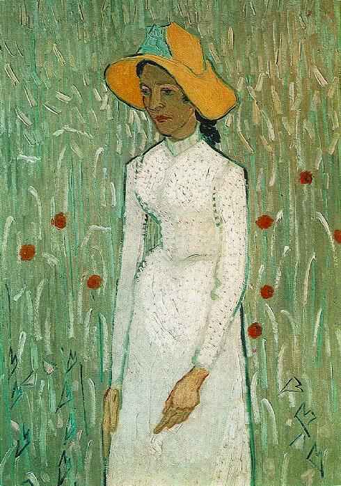 Young Girl Standing Against a Background of Wheat 